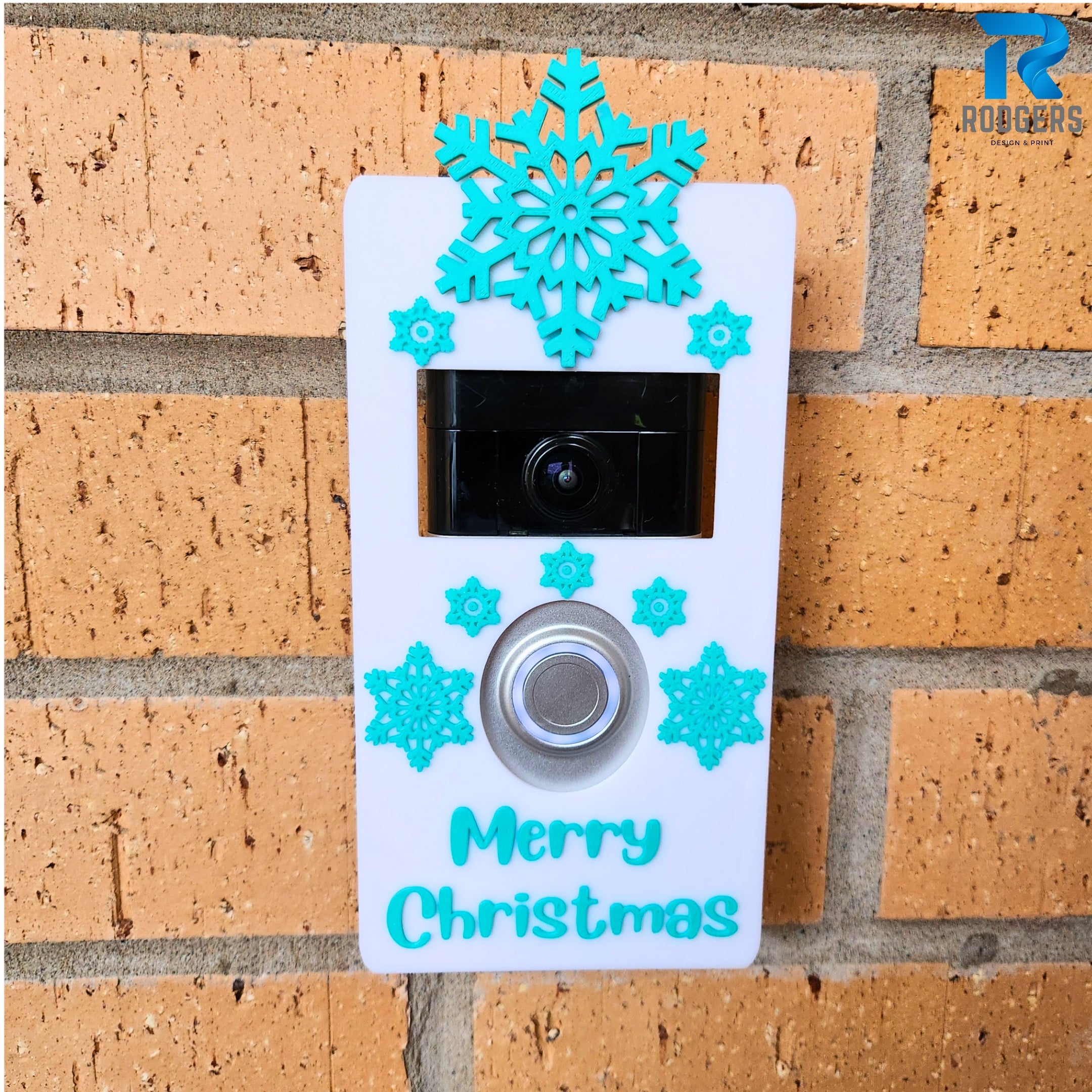 Festive Ring Doorbell cover featuring snowflakes, shown mounted on a door